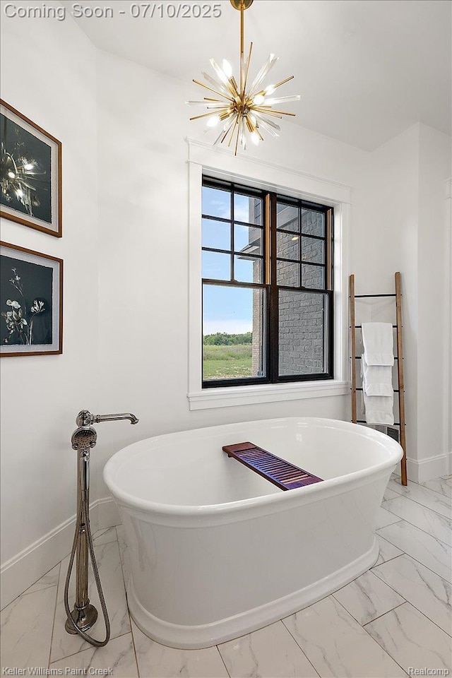 6295 Canter Creek Trl, Grand Blanc, MI 48439 - bathroom with marble look tile flooring, a chandelier, and a soaking tub