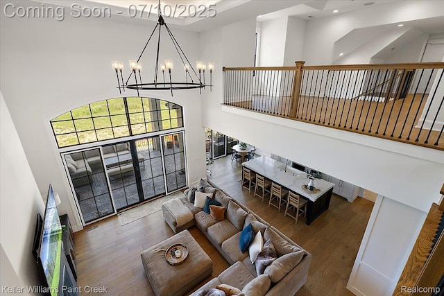 6295 Canter Creek Trl, Grand Blanc, MI 48439 - living area with a high ceiling, a chandelier, wood finished floors, and recessed lighting