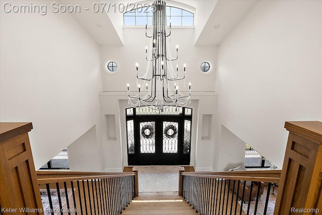 6295 Canter Creek Trl, Grand Blanc, MI 48439 - entryway with a high ceiling, a chandelier, wood finished floors, and plenty of natural light