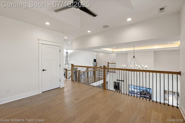6295 Canter Creek Trl, Grand Blanc, MI 48439 - hallway with a chandelier, wood finished floors, and recessed lighting