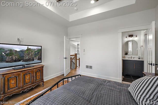 6295 Canter Creek Trl, Grand Blanc, MI 48439 - bedroom with wood finished floors, ensuite bath, and a raised ceiling