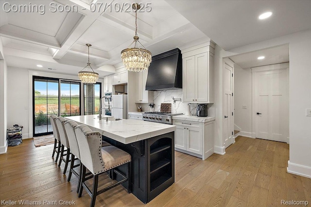 6295 Canter Creek Trl, Grand Blanc, MI 48439 - kitchen with custom exhaust hood, a chandelier, freestanding refrigerator, coffered ceiling, and recessed lighting