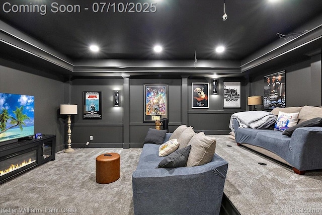 6295 Canter Creek Trl, Grand Blanc, MI 48439 - carpeted home theater with a tray ceiling, a glass covered fireplace, and recessed lighting
