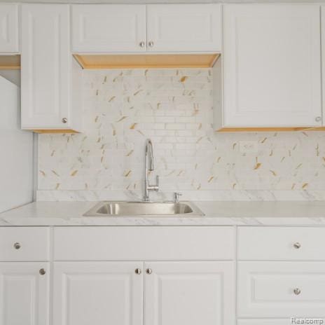 440 Jewell St, Southfield, MI 48220 - kitchen featuring light countertops, tasteful backsplash, and white cabinets