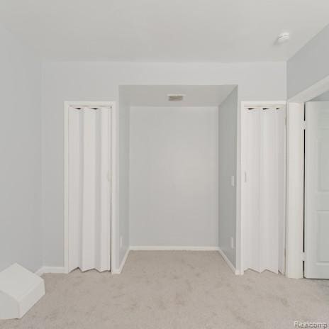 440 Jewell St, Southfield, MI 48220 - unfurnished bedroom featuring light carpet and multiple closets