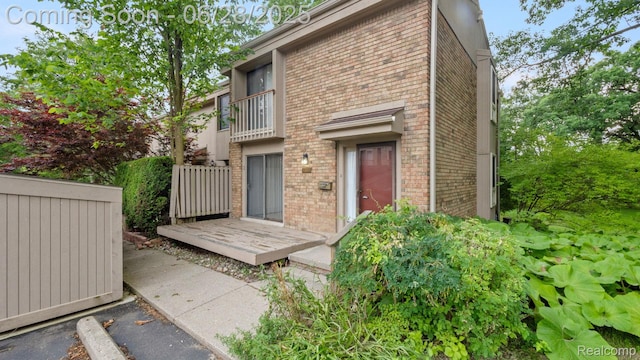 1481 Oakbrook E, Rochester, MI 48307 - rear view of house featuring brick siding and a balcony