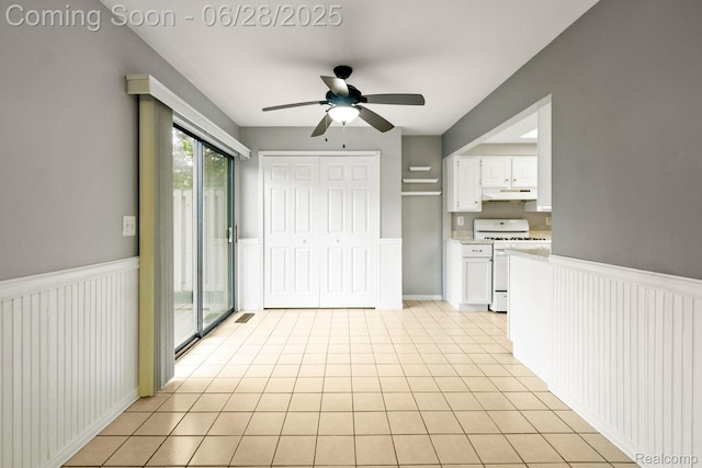 1481 Oakbrook E, Rochester, MI 48307 - kitchen featuring white gas range, under cabinet range hood, light countertops, ceiling fan, and white cabinets