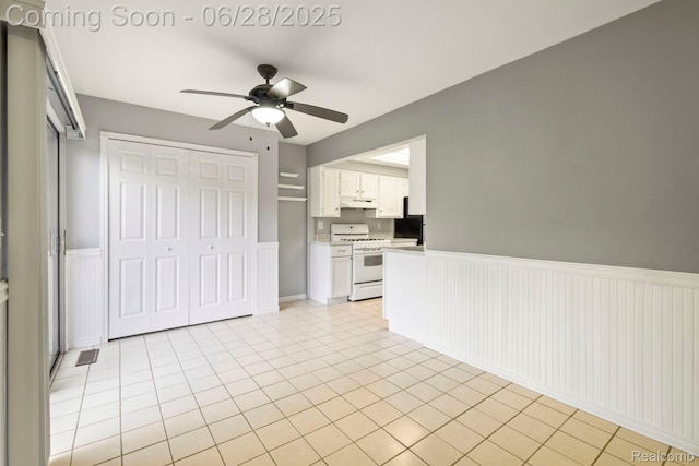 1481 Oakbrook E, Rochester, MI 48307 - unfurnished living room with a ceiling fan, a wainscoted wall, and light tile patterned flooring