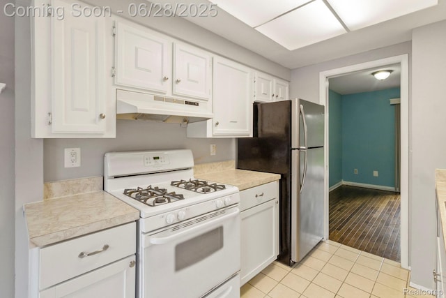 1481 Oakbrook E, Rochester, MI 48307 - kitchen with white gas range, under cabinet range hood, freestanding refrigerator, white cabinetry, and light countertops