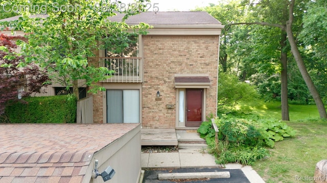 1481 Oakbrook E, Rochester, MI 48307 - view of front of home with brick siding and a balcony