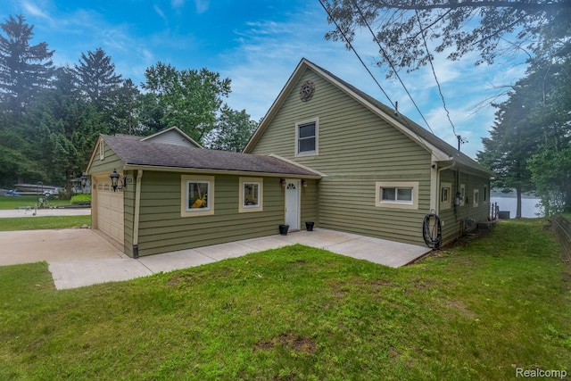 2624 Lynch, Highland, MI 48357 - rear view of house featuring driveway, a lawn, an attached garage, and a patio