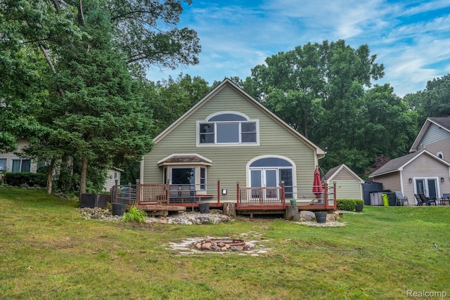 2624 Lynch, Highland, MI 48357 - back of house featuring a fire pit, a deck, and a yard