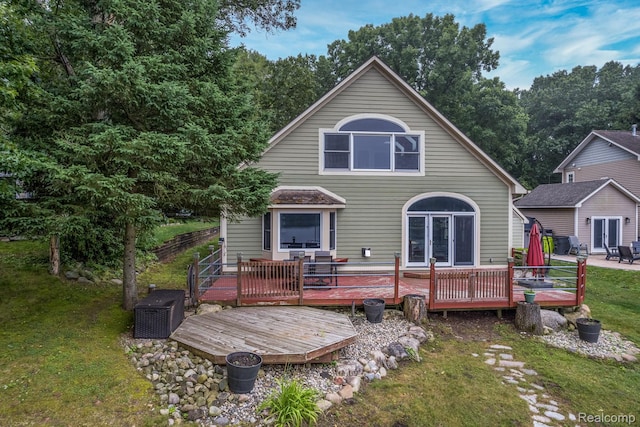 2624 Lynch, Highland, MI 48357 - rear view of house with a deck, french doors, and a yard