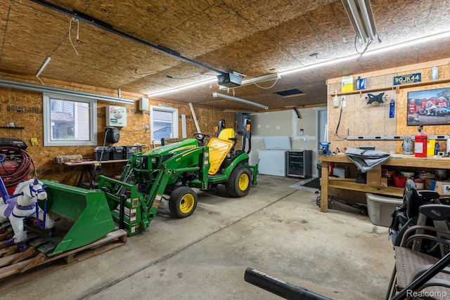 2624 Lynch, Highland, MI 48357 - garage featuring a garage door opener and a workshop area