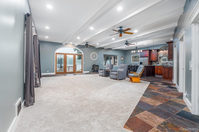 2624 Lynch, Highland, MI 48357 - living room featuring a ceiling fan, recessed lighting, beamed ceiling, stone tile floors, and a wood stove