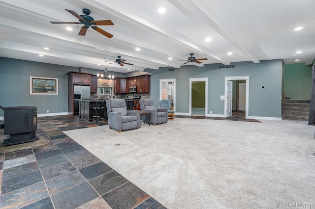 2624 Lynch, Highland, MI 48357 - living room featuring ceiling fan, a wood stove, recessed lighting, beamed ceiling, and stairs