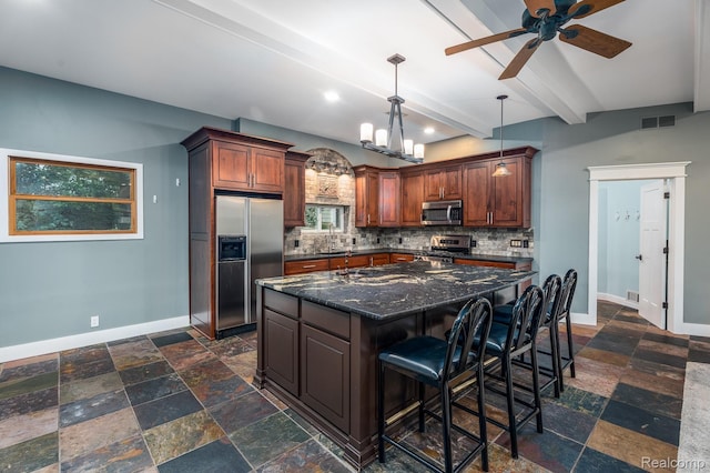 2624 Lynch, Highland, MI 48357 - kitchen featuring appliances with stainless steel finishes, stone tile flooring, tasteful backsplash, a ceiling fan, and a kitchen island