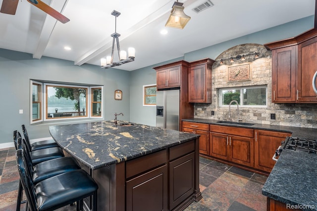2624 Lynch, Highland, MI 48357 - kitchen with stone tile flooring, stainless steel fridge, backsplash, beam ceiling, and a kitchen bar