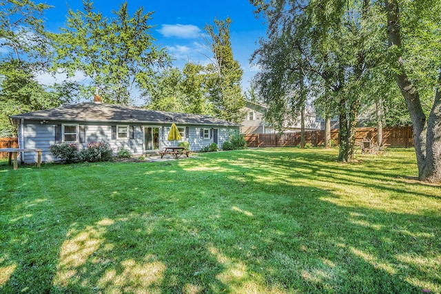 1315 Sutherland Ave, Kalamazoo, MI 49006 - back of house with a fenced backyard and a chimney