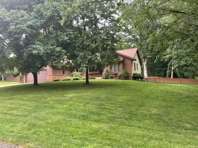 2360 Montclair Ave NW, Walker, MI 49544 - view of yard featuring an attached garage