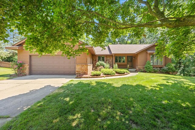 2360 Montclair Ave NW, Walker, MI 49544 - view of front of house with an attached garage, driveway, and brick siding
