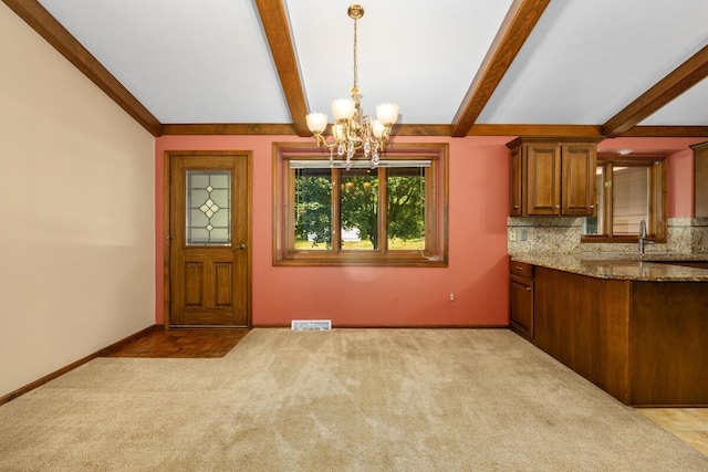 2360 Montclair Ave NW, Walker, MI 49544 - unfurnished dining area with a chandelier and light colored carpet