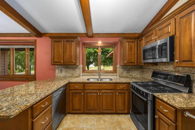 2360 Montclair Ave NW, Walker, MI 49544 - kitchen featuring black appliances, healthy amount of natural light, beam ceiling, light stone countertops, and tasteful backsplash
