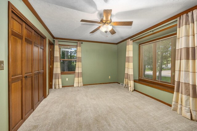 2360 Montclair Ave NW, Walker, MI 49544 - unfurnished bedroom with ornamental molding, carpet flooring, a ceiling fan, and a textured ceiling