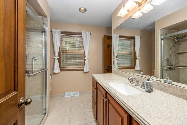 2360 Montclair Ave NW, Walker, MI 49544 - bathroom with vanity, a stall shower, and tile patterned flooring