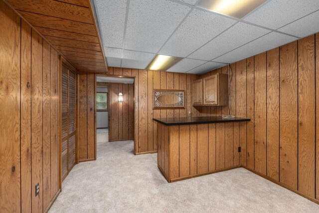 2360 Montclair Ave NW, Walker, MI 49544 - bar area featuring wooden walls, light colored carpet, and a drop ceiling