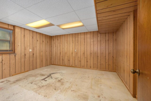 2360 Montclair Ave NW, Walker, MI 49544 - basement featuring a paneled ceiling and wooden walls