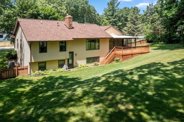 2360 Montclair Ave NW, Walker, MI 49544 - rear view of house featuring roof with shingles, a chimney, stairs, and a wooden deck