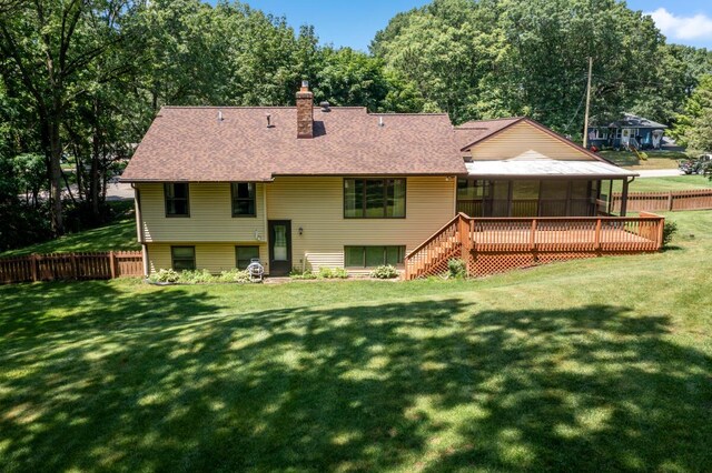 2360 Montclair Ave NW, Walker, MI 49544 - rear view of house featuring a sunroom, a chimney, and a shingled roof