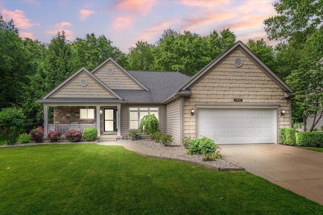 7520 Haflinger Cir, Kalamazoo, MI 49009 - view of front of house with a porch, driveway, a garage, a lawn, and a shingled roof