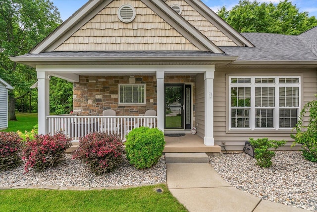 7520 Haflinger Cir, Kalamazoo, MI 49009 - view of exterior entry with covered porch and a shingled roof