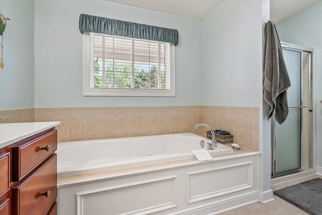 7520 Haflinger Cir, Kalamazoo, MI 49009 - bathroom featuring a bath, vanity, a shower stall, and tile patterned floors