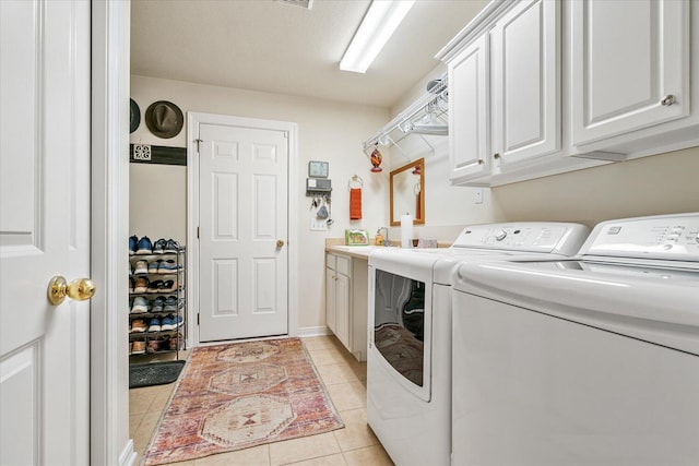 7520 Haflinger Cir, Kalamazoo, MI 49009 - washroom with separate washer and dryer, cabinet space, and light tile patterned floors