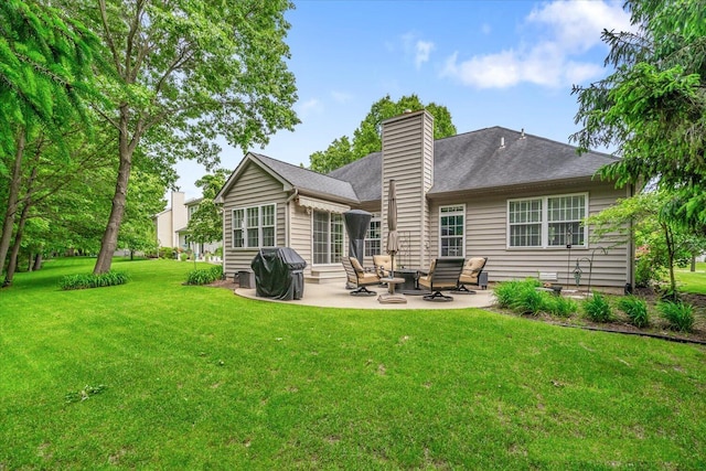 7520 Haflinger Cir, Kalamazoo, MI 49009 - back of property with a patio area, a yard, and a chimney