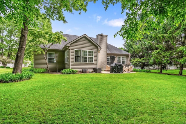 7520 Haflinger Cir, Kalamazoo, MI 49009 - rear view of house featuring a chimney, a lawn, a patio, and a shingled roof
