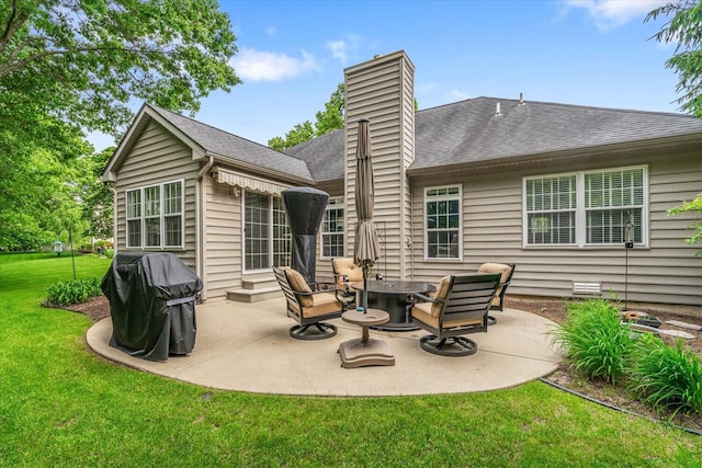 7520 Haflinger Cir, Kalamazoo, MI 49009 - rear view of property with a yard, a patio, a chimney, and roof with shingles