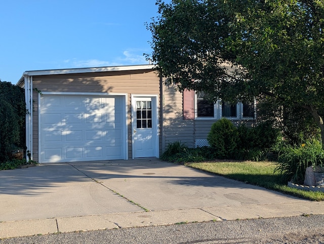 1310 Windridge Ln, Fremont, MI 49412 - view of front of home with concrete driveway and an attached garage