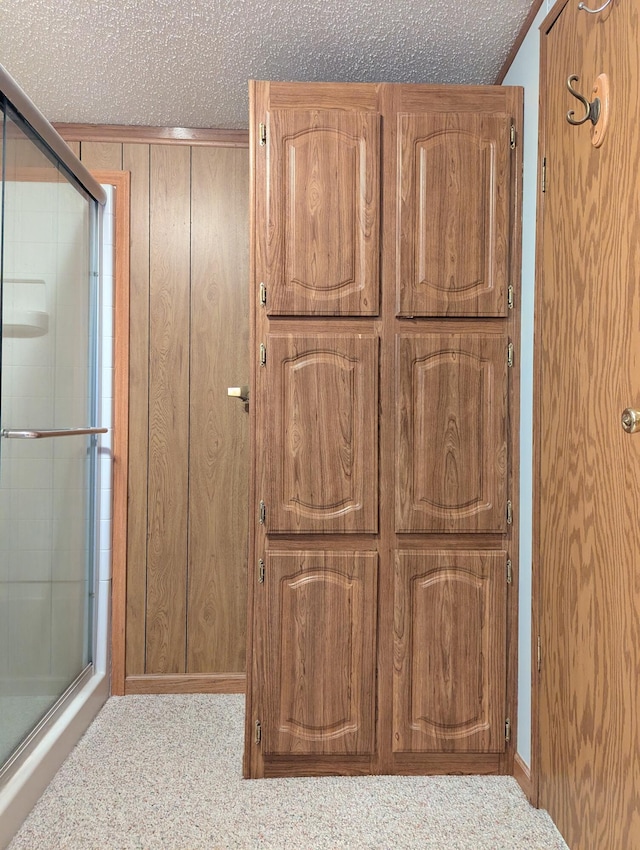 1310 Windridge Ln, Fremont, MI 49412 - full bath featuring a stall shower, a textured ceiling, and wooden walls