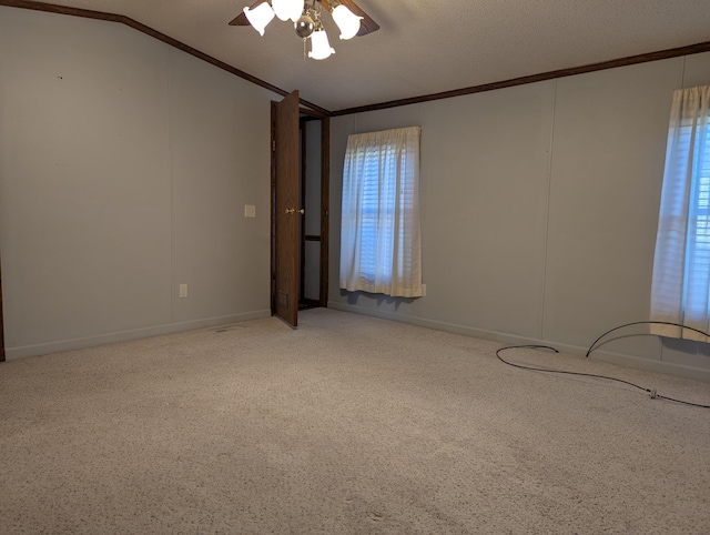1310 Windridge Ln, Fremont, MI 49412 - carpeted spare room with crown molding, ceiling fan, vaulted ceiling, and healthy amount of natural light