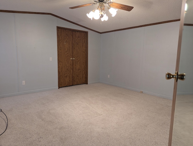 1310 Windridge Ln, Fremont, MI 49412 - unfurnished bedroom featuring vaulted ceiling, carpet flooring, a textured ceiling, crown molding, and a ceiling fan