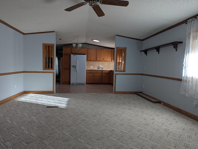 1310 Windridge Ln, Fremont, MI 49412 - kitchen with white refrigerator with ice dispenser, lofted ceiling, carpet floors, brown cabinetry, and open shelves