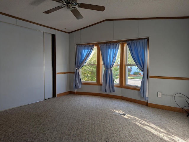 1310 Windridge Ln, Fremont, MI 49412 - spare room with lofted ceiling, crown molding, carpet floors, a textured ceiling, and a ceiling fan