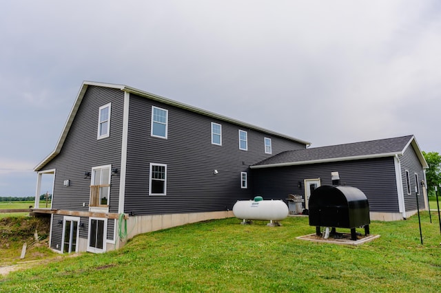 2634 Fitzgerald Ave, Fremont, MI 49412 - back of property featuring oil tank and a lawn