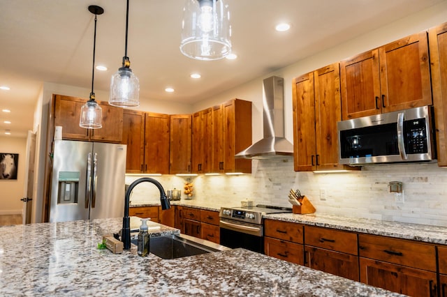 2634 Fitzgerald Ave, Fremont, MI 49412 - kitchen with stainless steel appliances, wall chimney exhaust hood, light stone countertops, pendant lighting, and recessed lighting