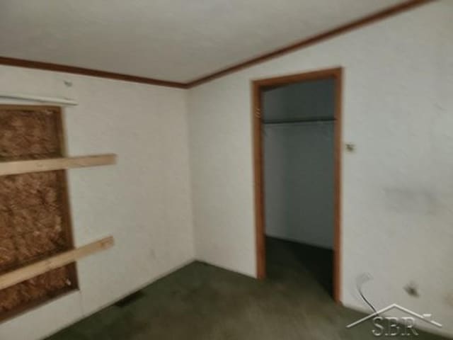 2502 Lynnwood Ave, Saginaw, MI 48601 - unfurnished bedroom featuring carpet floors and crown molding