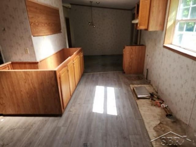 2502 Lynnwood Ave, Saginaw, MI 48601 - kitchen featuring light wood-style floors and wallpapered walls